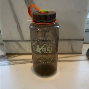 REI Brown Water Bottle with Orange Cap